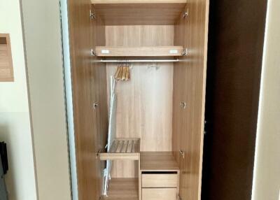 Open wooden closet with shelves and hangers