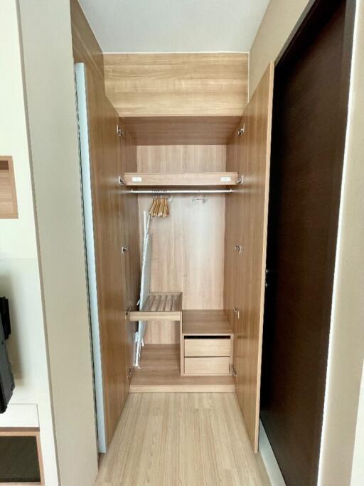 Open wooden closet with shelves and hangers