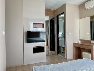 Modern bedroom with TV and vanity desk