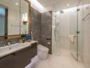 Modern bathroom with glass shower and marble walls