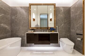 Modern elegant bathroom with large mirror and marble walls