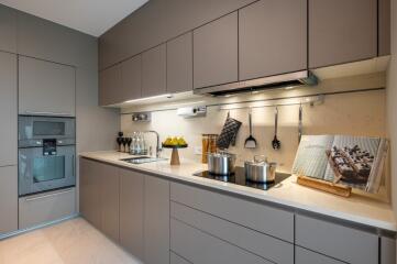 Modern, well-equipped kitchen with sleek cabinetry and built-in appliances