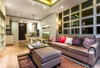 Modern living room with comfortable sofas and open kitchen