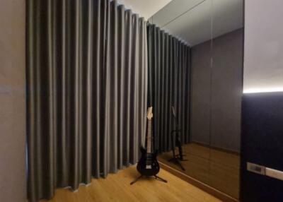 Living area with curtains and a guitar