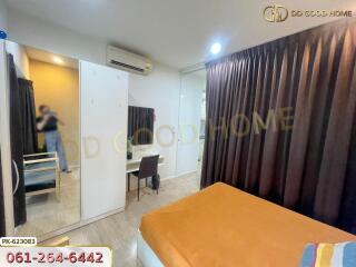 Well-lit bedroom with study area and mirrored wardrobe