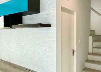 Modern hallway with floating shelves and staircase