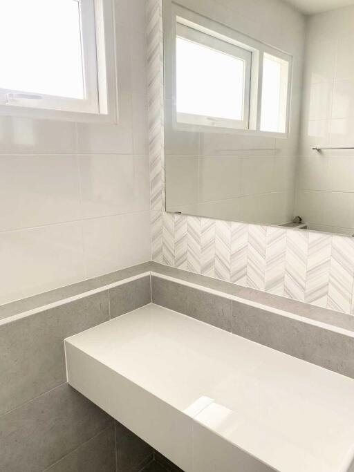 Modern bathroom with white countertop and large mirror