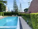 Outdoor swimming pool with poolside seating area