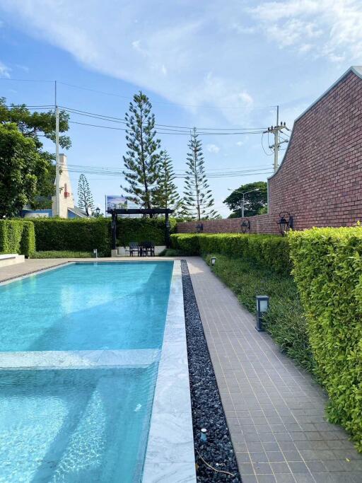 Outdoor swimming pool with poolside seating area