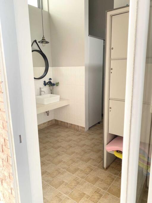 Modern bathroom with sink and storage lockers