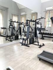 Home gym with exercise equipment and large mirror