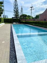 Spacious swimming pool with surrounding greenery