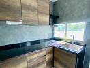 Modern kitchen with wooden cabinets and black countertop