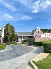 Exterior of a house with a paved driveway and landscaped garden