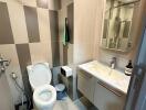 Modern bathroom view with sink, toilet, and tiled walls