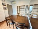 Dining room with wooden table and empty shelves