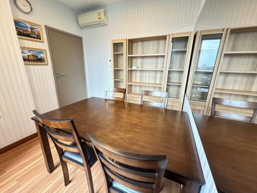 Dining room with wooden table and empty shelves