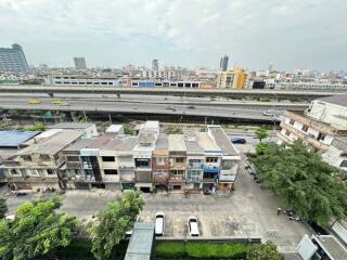 Aerial view of a cityscape with buildings and highway