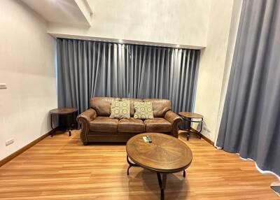 Living room with brown leather sofa and wooden coffee table