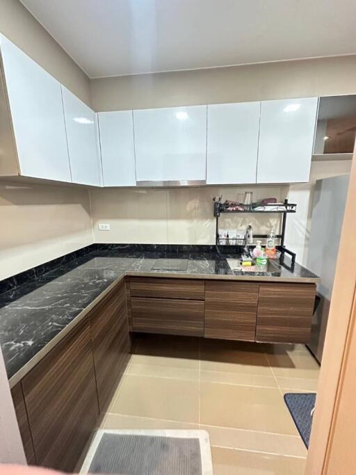 Modern kitchen with marble countertops and ample storage