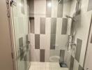 Modern bathroom with glass shower enclosure and tiled walls