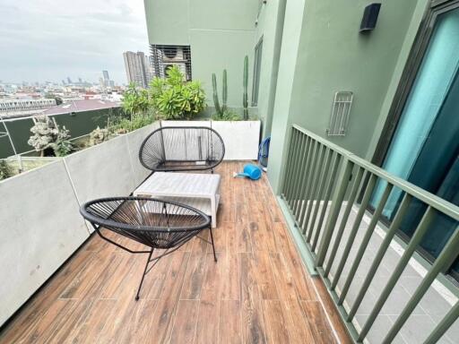 Spacious balcony with seating area and plants