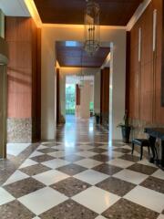 Lobby area with checkered flooring and elegant lighting fixtures