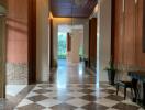 Lobby area with checkered flooring and elegant lighting fixtures