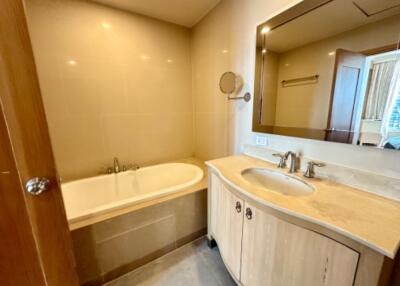 A modern bathroom with a bathtub and a vanity with a sink and mirror