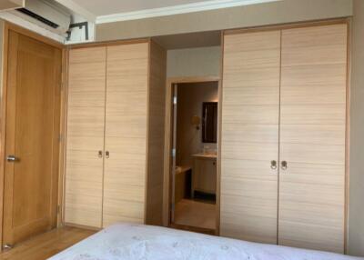 Bedroom with built-in wardrobes and view into the bathroom