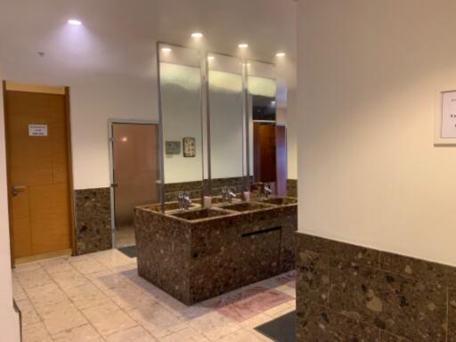 Modern bathroom with granite countertops and large mirrors