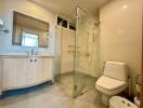 Modern bathroom with a glass shower enclosure and white fixtures