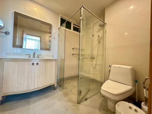 Modern bathroom with a glass shower enclosure and white fixtures