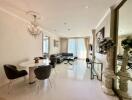 Modern living room with dining area and chandelier