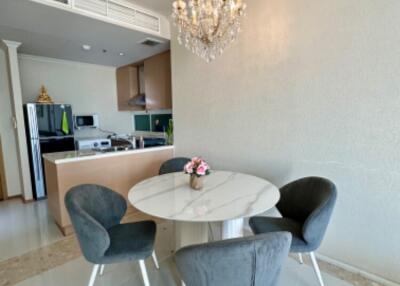 Dining area with modern chandelier and round table with four chairs