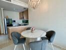 Dining area with modern chandelier and round table with four chairs