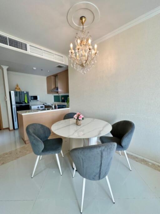 Dining area with modern chandelier and round table with four chairs