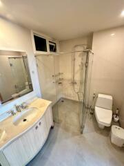 Modern bathroom with glass shower and white fixtures