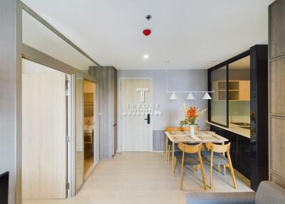 Modern dining area with a small table and chairs, adjacent to the kitchen