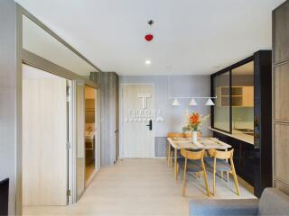 Modern dining area with a small table and chairs, adjacent to the kitchen