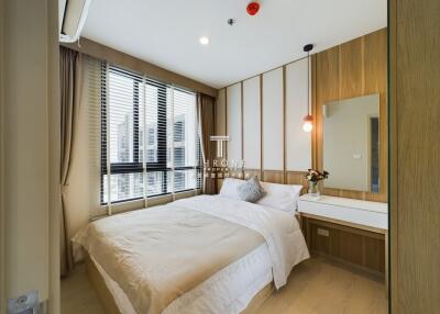 Modern bedroom with a large window, bed, and vanity table.