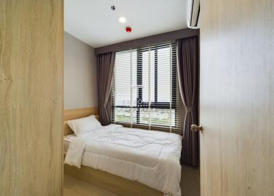 A modern small bedroom with bed and window view