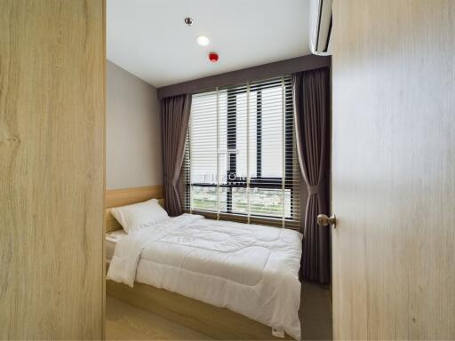 A modern small bedroom with bed and window view