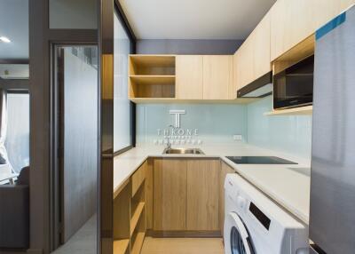 Modern kitchen with wooden cabinets and integrated appliances