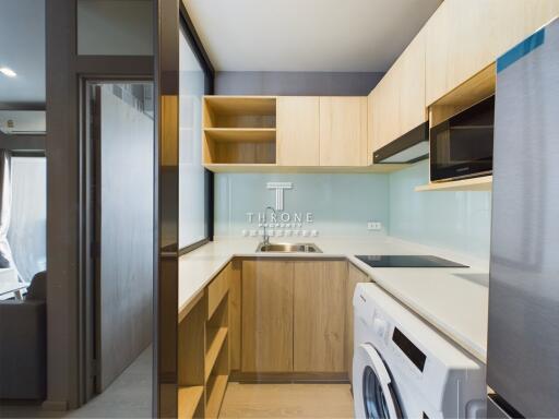 Modern kitchen with wooden cabinets and integrated appliances