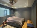 Modern bedroom with a platform bed and ceiling fan