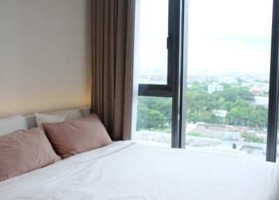 Modern bedroom with a large window and a view