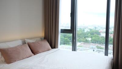 Modern bedroom with a large window and a view