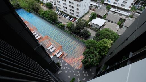 View of a building with a swimming pool and parking lot