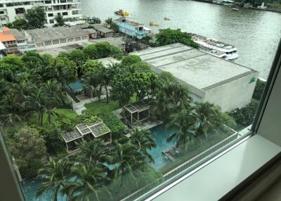 View from window overlooking pool, greenery, and river